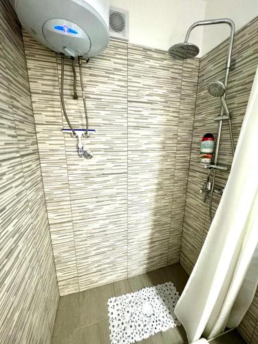 a bathroom with a shower with a sink and a shower at Apartment Kontrada in Umag