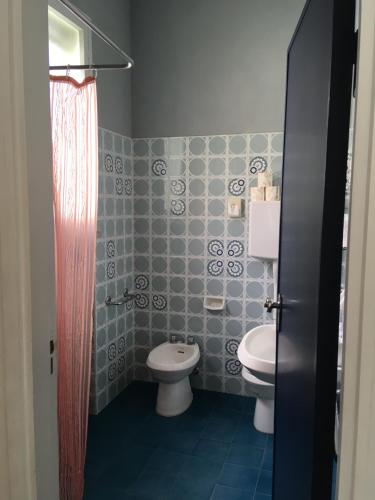 a bathroom with a toilet and a sink at Hotel Maddalena in Marina di Ravenna