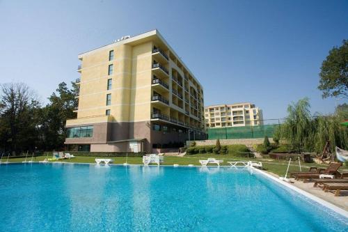 a large swimming pool in front of a building at Studios in Sveta Elena complex with mineral pool in St. St. Constantine and Helena