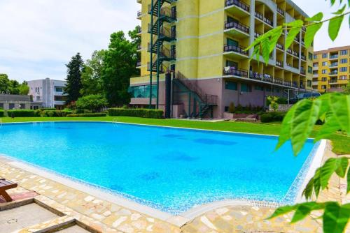 a large swimming pool in front of a building at Studios in Sveta Elena complex with mineral pool in St. St. Constantine and Helena
