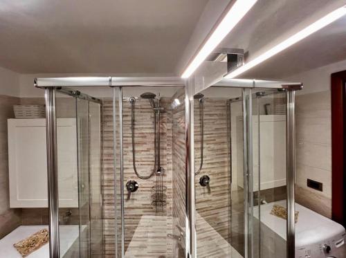 a bathroom with a shower with a glass shower stall at Light House Bisceglie in Bisceglie
