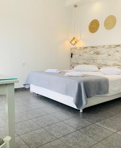 a bedroom with a bed and a table at Anemos Studios in Adamas