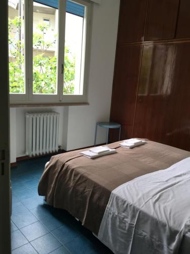 a bedroom with a bed with two towels on it at Hotel Maddalena in Marina di Ravenna