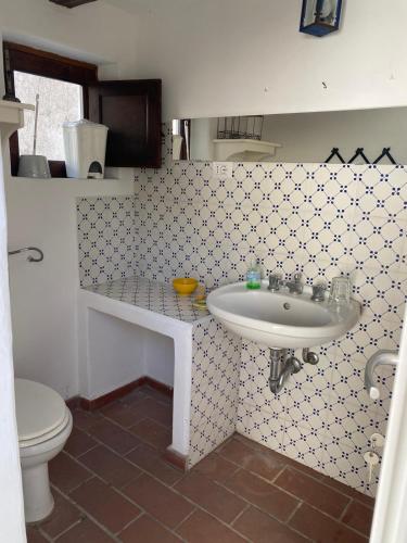 a bathroom with a sink and a toilet at Casa Lilian in Stromboli