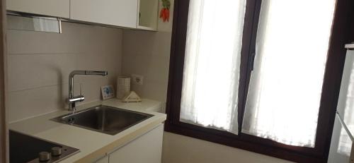 a kitchen with a sink and a window at Sa Frummiga in Cagliari