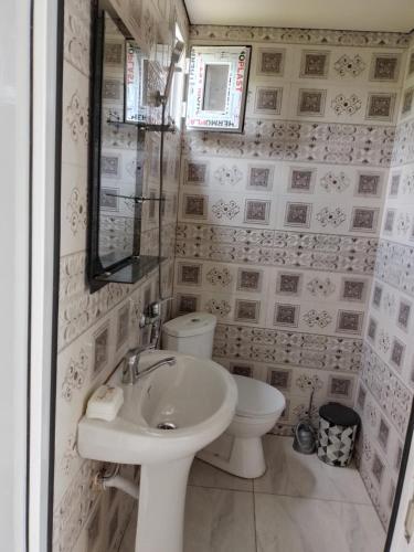 een witte badkamer met een wastafel en een toilet bij Bagrationi 54 in Kobuleti