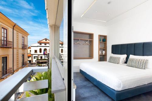 Postel nebo postele na pokoji v ubytování Hotel Tasso Suites & Spa