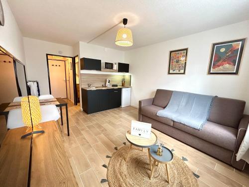 a living room with a couch and a table at Studio calais la plage in Calais