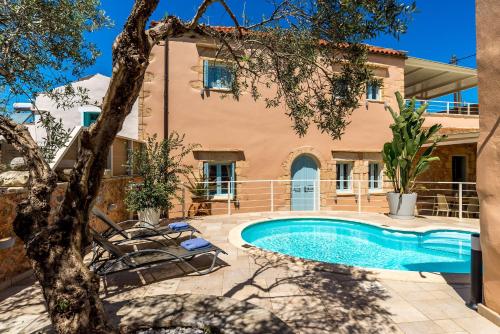 a villa with a swimming pool and a house at Cellar Villa in Xirosterni in Xirostérnion