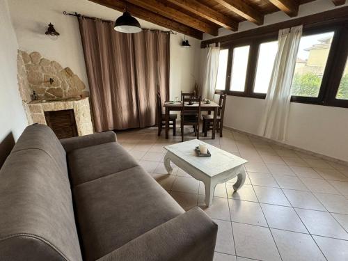a living room with a couch and a table at Casa Vacanze Chiara in Olbia