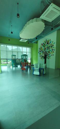 a large room with chairs and a tree on the wall at Doma House Onsen at Sunway Onsen, Tambun in Ipoh