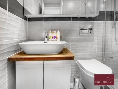 a bathroom with a sink and a toilet at Bracknell -58c Harmanswater Road - 2 bedroom apartment in Bracknell