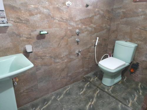 a bathroom with a toilet and a sink at Sanji villa in Beliatta