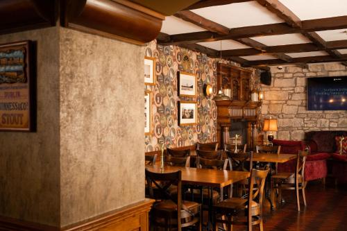 a restaurant with tables and chairs in a room at Manor House Country Hotel in Enniskillen