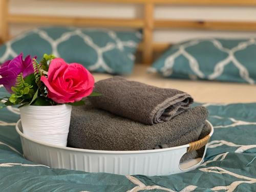 a basket with towels and a flower on a bed at Holiday home Dallas in Dallas