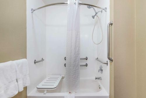 a bathroom with a shower with a toilet and a tub at Comfort Inn Grain Valley in Grain Valley