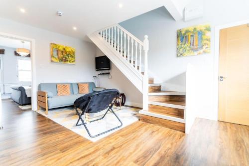 een woonkamer met een bank en een trap bij Moseley Haven 2 - Bed Luxury in Birmingham