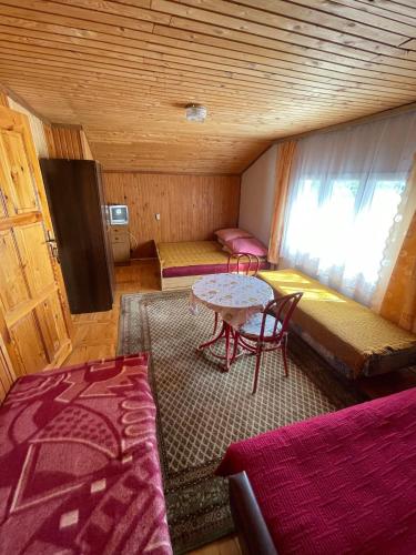 a room with two beds and a table in a room at Dom nad Solinką in Wołkowyja