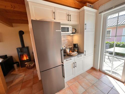 a kitchen with a refrigerator and a stove at Ferienhaus Anna - rechte Seite in Dranske