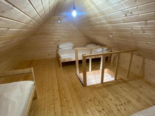 a room with two bunk beds in a wooden cabin at Resort Pirates in Dziwnow for 4 persons in Dziwnów