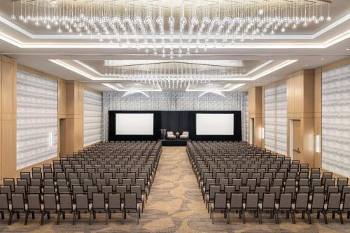 an empty hall with chairs and blank screens at Hilton BNA Nashville Airport Terminal in Nashville