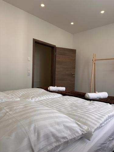 a large white bed with two pillows on top of it at AMAO Obsidian - 120 m2 Business & Family Apartment - 3 Bedrooms - 8 Guests - King-Size Beds in Schwanau