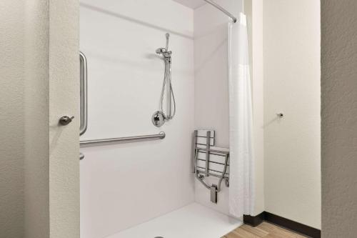 a shower stall in a bathroom with a shower curtain at Everhome Suites Nampa Boise in Nampa