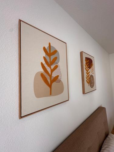 a framed picture of a plant on a wall at AMAO Obsidian - 120 m2 Business & Family Apartment - 3 Bedrooms - 8 Guests - King-Size Beds in Schwanau