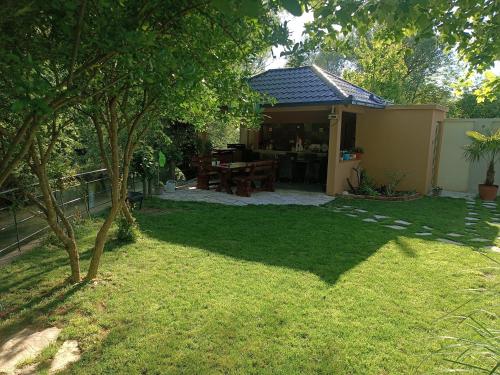 a backyard with a picnic table and a house at Apartman Natura vita Blagaj in Blagaj