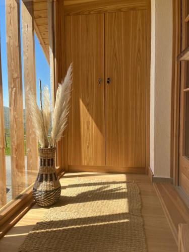 a hallway with a vase with feathers in it at House-tanjevica in Kostanjevica na Krki