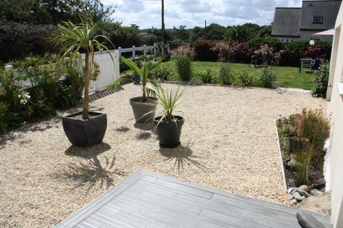 a garden with three potted plants in a yard at L 'Air Yaudet in Becléguer