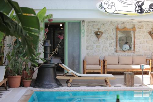 a house with a pool and a chair and a couch at Brera Alacati - Special Category in Alaçatı