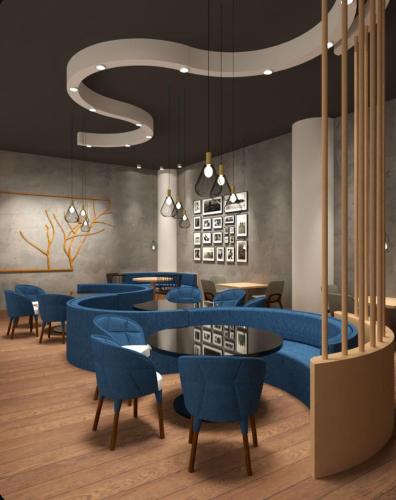 a restaurant with blue tables and blue chairs at wellness at Don Borrello in Bolton