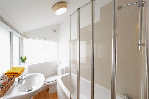 a bathroom with a shower and a toilet and a sink at Town Centre House for 6 Guests in Bournemouth