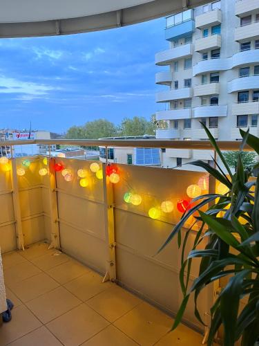 a balcony with lights on the side of a building at Apartament WITOMINO in Gdynia