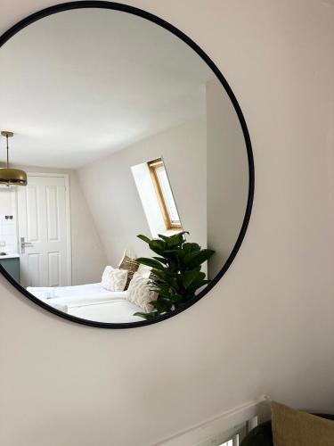 a mirror hanging on a wall in a bedroom at Rembrandtplein Apartments in Amsterdam