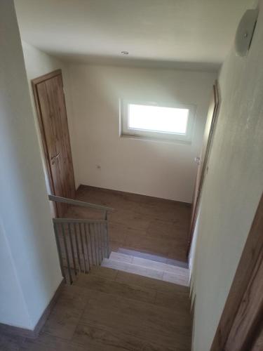 a staircase in a room with a window and a stair case at Chata na šírave in Kaluža