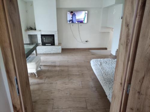 a living room with a television on the wall at Chata na šírave in Kaluža