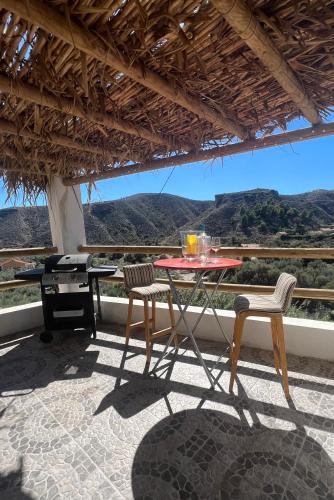 a table and chairs on a patio with a view at Rambla Retreats Apartment Azul with shared pool & hot tub in Oria in Oria