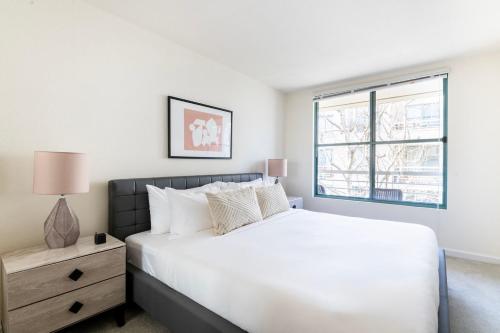 a bedroom with a white bed and a window at South Beach 1br w sauna pool near stadium SFO-1662 in San Francisco