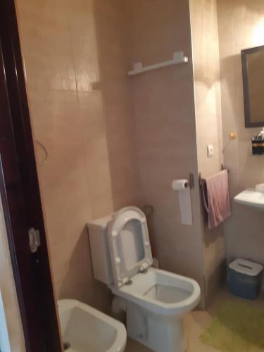 a bathroom with a white toilet and a sink at Beralmar in Asilah