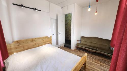 a bedroom with a bed and a couch at Ulaanbaatar Hostel in Ulaanbaatar