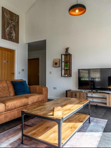 a living room with a couch and a coffee table at Shoreland Lodges - Cherry Lodge in Fort Augustus
