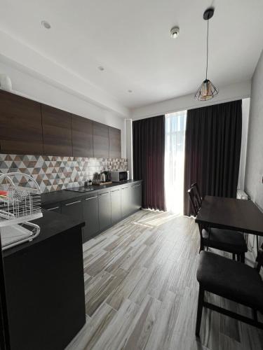 a kitchen with a table and a dining room at Mayster Home in Chernivtsi