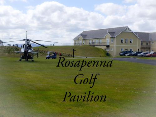 a helicopter is parked in a grassy field at Mews Apartment Main St, Carrigart, F92HC04 in Carrigart