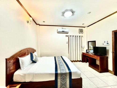 Voodi või voodid majutusasutuse Heuang Paseuth Hotel 香帕赛酒店 toas