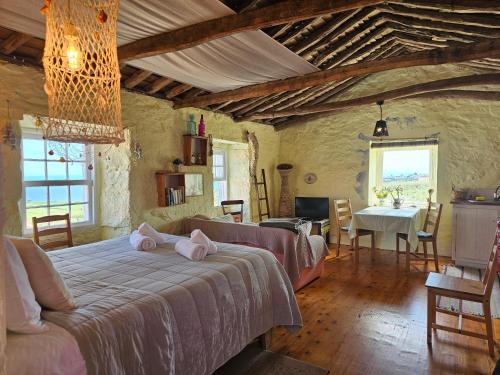 Casa Anjos Holiday Cottages في Areias: غرفة نوم مع سرير مع وسائد وردية عليه
