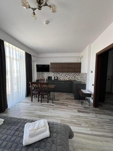 a living room with a kitchen and a dining room at Mayster Home in Chernivtsi