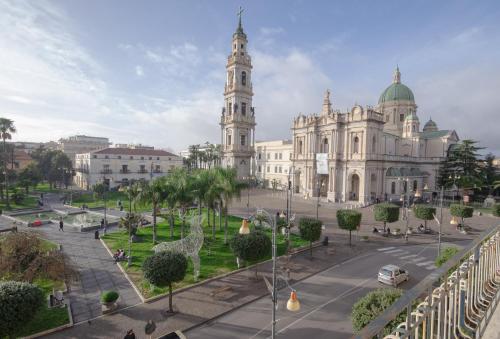 a large white building with a clock tower at 49 Downtown Pompeii in Pompei