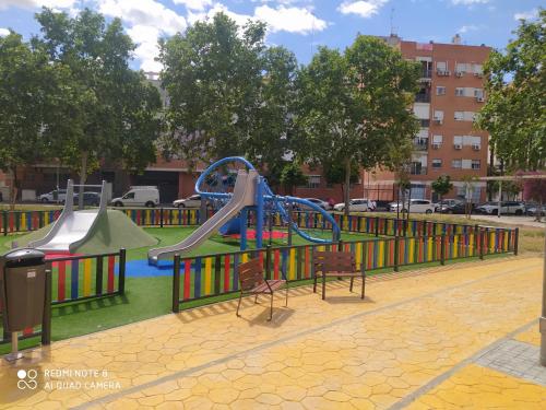 a playground with a slide in a park at Estudio Palacio Congresos in Seville